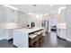 Bright kitchen featuring white cabinets, marble backsplash, and a large island at 1763 Stargazer Ter, Sanford, FL 32771