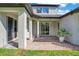 Brick paved patio with covered seating area and lush greenery at 1763 Stargazer Ter, Sanford, FL 32771