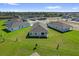 Aerial view of a new construction home with green lawn, surrounded by a residential community at 1864 Maple Plum Ct, Sanford, FL 32771