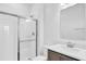 Bright bathroom featuring a tiled shower with glass door, vanity with modern faucet, and large mirror at 1864 Maple Plum Ct, Sanford, FL 32771