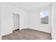 Bright bedroom with wood-look floors, closet with bifold doors and a sunny window at 1864 Maple Plum Ct, Sanford, FL 32771