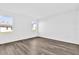 Bedroom featuring new laminate flooring, white walls, and windows providing natural light at 1864 Maple Plum Ct, Sanford, FL 32771