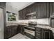 Modern kitchen with dark wood cabinets and stainless steel appliances at 1937 Eland Ave, Winter Park, FL 32789