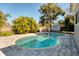 Relaxing kidney shaped pool with gray paver decking at 1937 Eland Ave, Winter Park, FL 32789