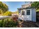 Gray shed with white trim nestled in a lush backyard landscape at 1937 Eland Ave, Winter Park, FL 32789