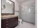 Modern bathroom with a glass shower, granite countertop, and dark brown vanity at 2224 Alaqua Dr, Longwood, FL 32779