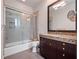 Clean bathroom with a shower/tub combo, granite countertop, and dark brown vanity at 2224 Alaqua Dr, Longwood, FL 32779