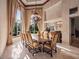 Formal dining room with large table, chandelier, and ample natural light at 2224 Alaqua Dr, Longwood, FL 32779