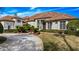 Grand two-story home with a tile roof and manicured landscaping at 2224 Alaqua Dr, Longwood, FL 32779