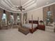 Main bedroom featuring a king-size bed and a sitting area at 2224 Alaqua Dr, Longwood, FL 32779