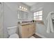 Updated bathroom with granite vanity, modern fixtures and a large mirror at 2231 Deloraine Trl, Maitland, FL 32751