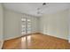 Bedroom with wood flooring and French doors that open to the pool area at 2231 Deloraine Trl, Maitland, FL 32751