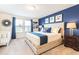 Main bedroom with king-size bed and blue accent wall at 2432 Dubai St, Kissimmee, FL 34747