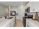 Modern kitchen with white cabinets, stainless steel appliances, and large island at 2468 Penguin Blvd, Davenport, FL 33837