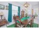 Elegant dining room with green rug and decorative accents at 2555 Yellow Brick Rd, St Cloud, FL 34772