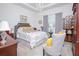 Spacious main bedroom with a plush bed and seating area at 2555 Yellow Brick Rd, St Cloud, FL 34772