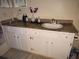 Bathroom with granite countertop and white cabinets at 2624 Robert Trent Jones Dr # 615, Orlando, FL 32835