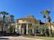 Community clubhouse with columns and landscaping at 2624 Robert Trent Jones Dr # 615, Orlando, FL 32835