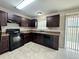 Modern kitchen with dark cabinets, black appliances and patio access at 2650 Sw 162Nd Ln, Ocala, FL 34473