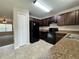 Modern kitchen with dark cabinets, black appliances, and granite countertops at 2650 Sw 162Nd Ln, Ocala, FL 34473