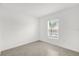 Bright bedroom with neutral walls, tile flooring, and a window providing natural light at 2664 Hancock Crossing Dr, Bartow, FL 33830