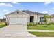 Charming one-story home featuring a two-car garage, well-manicured lawn, and inviting curb appeal at 2664 Hancock Crossing Dr, Bartow, FL 33830