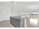 Kitchen island with granite countertop that overlooks an open living space and outdoor view at 2664 Hancock Crossing Dr, Bartow, FL 33830