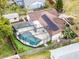 Aerial view of a home with a screened-in pool, solar panels, fenced backyard, and mature landscaping at 2717 Rose Moss Ln, Orlando, FL 32807