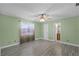 Bedroom with light green walls, tile floors, ceiling fan, and a view into the connected bathroom at 2717 Rose Moss Ln, Orlando, FL 32807