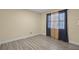 Bedroom featuring neutral walls, wood-look tile flooring, and a window with blue and floral curtains at 2717 Rose Moss Ln, Orlando, FL 32807