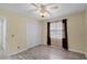 Bright bedroom boasts tile flooring, a ceiling fan, a window with curtains, and a double-door closet at 2717 Rose Moss Ln, Orlando, FL 32807