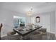 Dining room features seating for six, modern light fixtures, and access to living and entry areas at 2717 Rose Moss Ln, Orlando, FL 32807