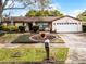 Well-maintained single-story home with a manicured lawn and a charming front yard centerpiece at 2717 Rose Moss Ln, Orlando, FL 32807