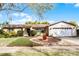 Inviting single-story home with a well-kept lawn and a lovely circular garden feature in the front yard at 2717 Rose Moss Ln, Orlando, FL 32807