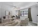 Bright living room with a neutral color palette, modern furnishings, and lots of natural light at 2717 Rose Moss Ln, Orlando, FL 32807