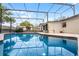 Refreshing screened-in pool with a well-maintained patio and stunning blue water at 2717 Rose Moss Ln, Orlando, FL 32807