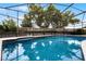 Clean pool featuring a screened-in enclosure and a view of the backyard at 2717 Rose Moss Ln, Orlando, FL 32807