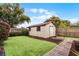 Exterior view of the shed in backyard with tidy landscaping and lush greenery at 2717 Rose Moss Ln, Orlando, FL 32807