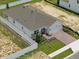 An aerial view of a bright, single-Gathering home featuring a fenced yard and brick driveway at 27469 Black Kite Ave, Howey In The Hills, FL 34737