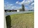Spacious backyard featuring a white fence, new construction houses, and healthy green grass at 27469 Black Kite Ave, Howey In The Hills, FL 34737