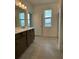 Bright bathroom featuring a double sink vanity, tiled floor and shower-over-tub perfect for a growing Gathering at 27469 Black Kite Ave, Howey In The Hills, FL 34737
