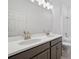 Bright bathroom with double sinks, modern fixtures, spacious vanity, and a combination shower and tub at 27469 Black Kite Ave, Howey In The Hills, FL 34737