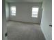 Spacious bedroom with two windows offering plenty of natural light and plush neutral carpet flooring at 27469 Black Kite Ave, Howey In The Hills, FL 34737
