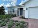 Charming front entrance features stone accents and a brick paver walkway at 27469 Black Kite Ave, Howey In The Hills, FL 34737