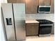 Close-up view of the kitchen featuring a stainless steel refrigerator and gas range at 27469 Black Kite Ave, Howey In The Hills, FL 34737