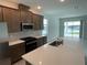 Modern kitchen features a large island, stainless steel appliances, and abundant cabinet space at 27469 Black Kite Ave, Howey In The Hills, FL 34737