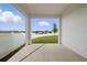 Covered patio offers a relaxing outdoor space overlooking the backyard and fence at 27469 Black Kite Ave, Howey In The Hills, FL 34737