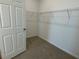 Spacious walk-in closet fitted with wire shelving, perfect for storage and organization at 27469 Black Kite Ave, Howey In The Hills, FL 34737