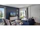 Living room with navy blue accent wall, sliding glass doors, and a modern coffee table at 2789 Flushing Dr, Apopka, FL 32703