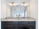 Double vanity bathroom with granite countertop and large mirror at 3196 Crown Jewel Ct, Winter Park, FL 32792